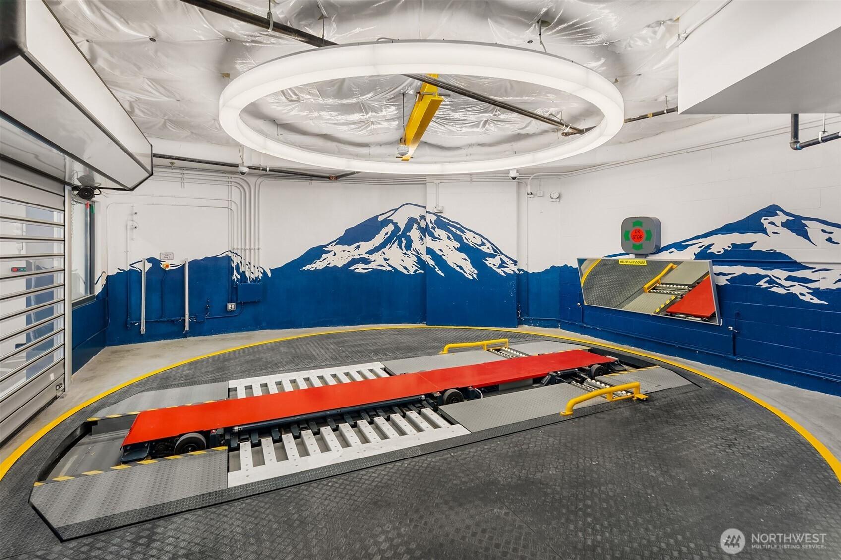 Seattle First! Automated parking and EV Robotic Charging. Tech parks and charges your car for you! Parking Available for purchase.